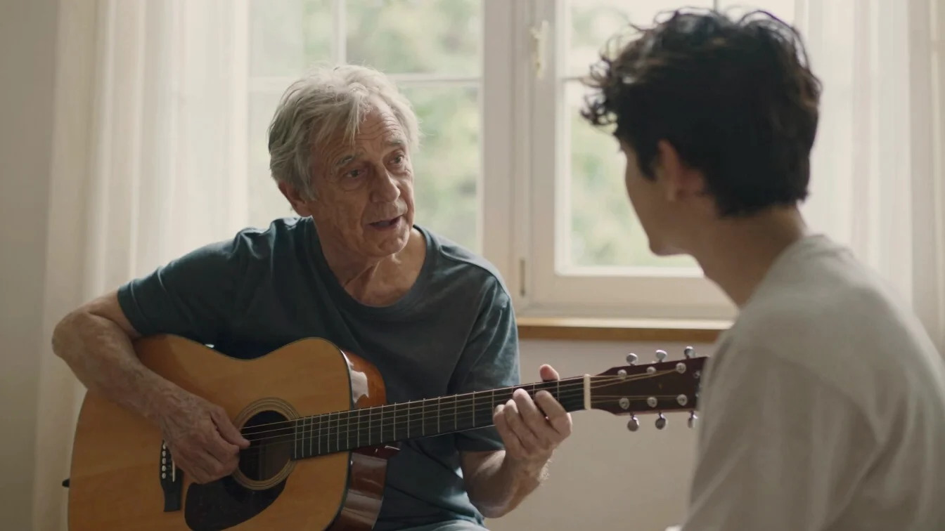 Warm interaction between an older musician and a younger companio